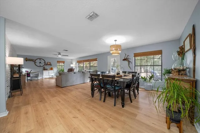 a view of a dining room with furniture and chandelier