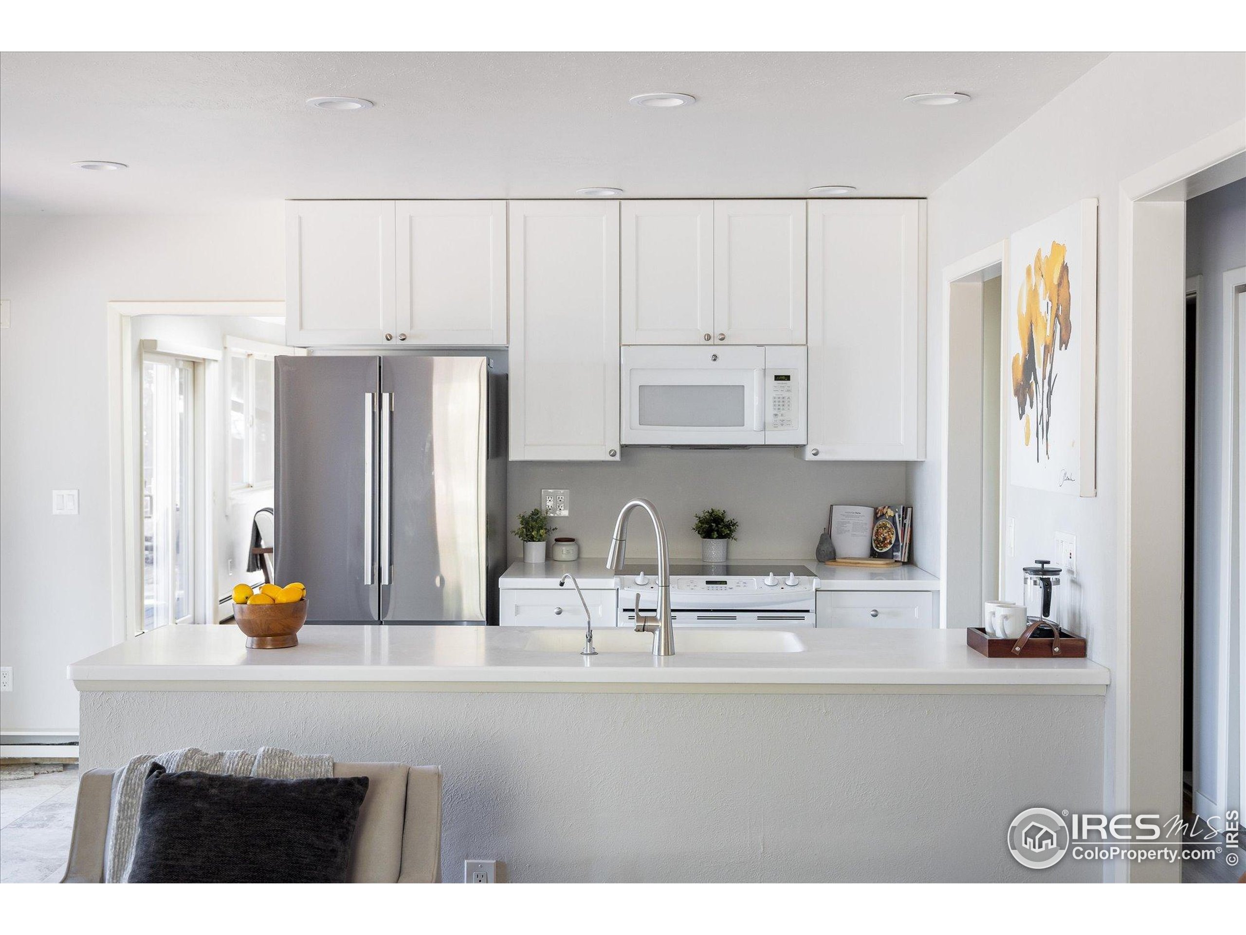 a kitchen with stainless steel appliances a sink and cabinets