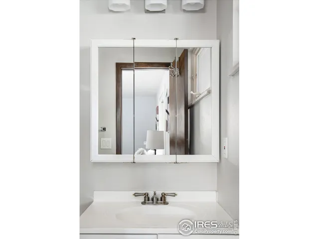 a bathroom with a sink a mirror and a window