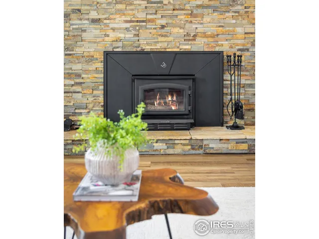a kitchen with a fireplace and a potted plant