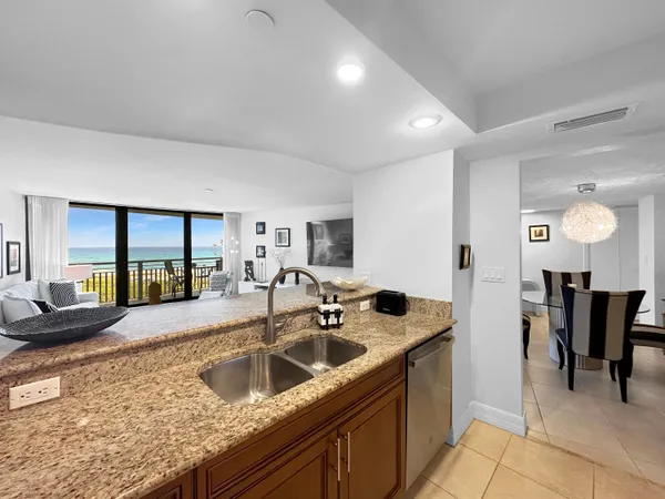 a kitchen with a sink and living room