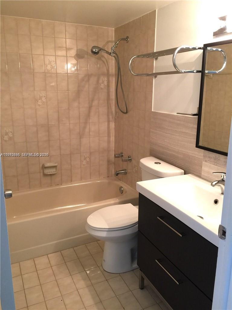 11750 Southwest 18th Street, Unit 5271 Miami, FL 33175 - Photo 2 of 8 a bathroom with a sink a toilet and shower
