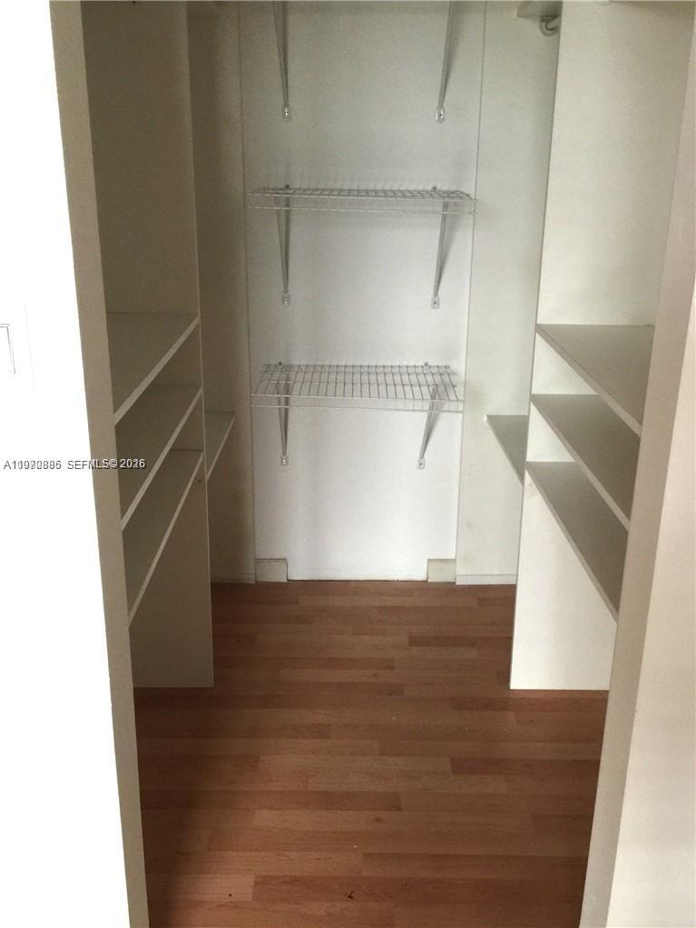 11750 Southwest 18th Street, Unit 5271 Miami, FL 33175 - Photo 3 of 8 a view of walk in closet with empty racks