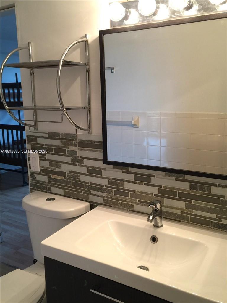11750 Southwest 18th Street, Unit 5271 Miami, FL 33175 - Photo 4 of 8 a bathroom with a sink and a mirror