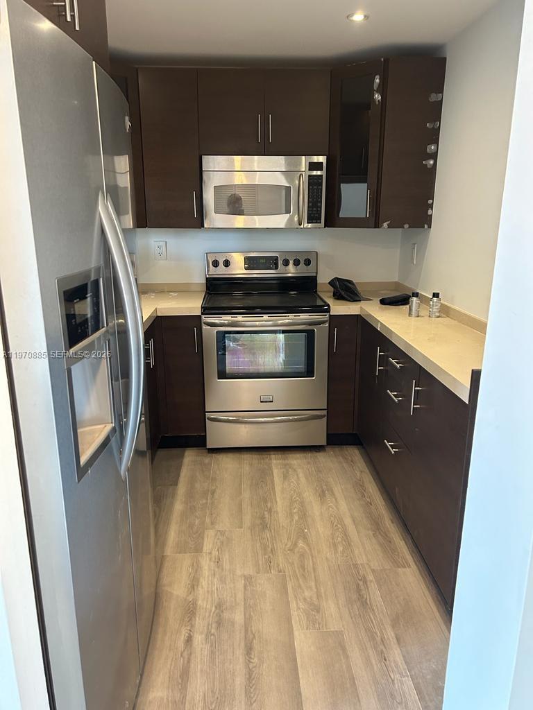 11750 Southwest 18th Street, Unit 5271 Miami, FL 33175 - Photo 5 of 8 a kitchen with stainless steel appliances and cabinets
