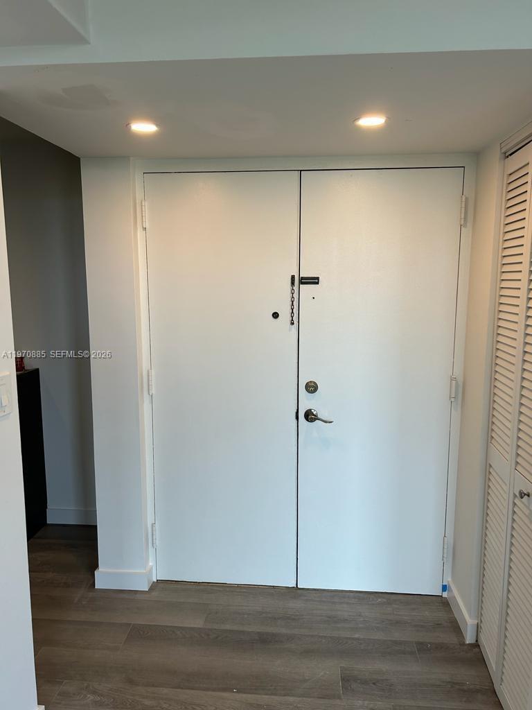 11750 Southwest 18th Street, Unit 5271 Miami, FL 33175 - Photo 6 of 8 a view of an empty room with wooden floor