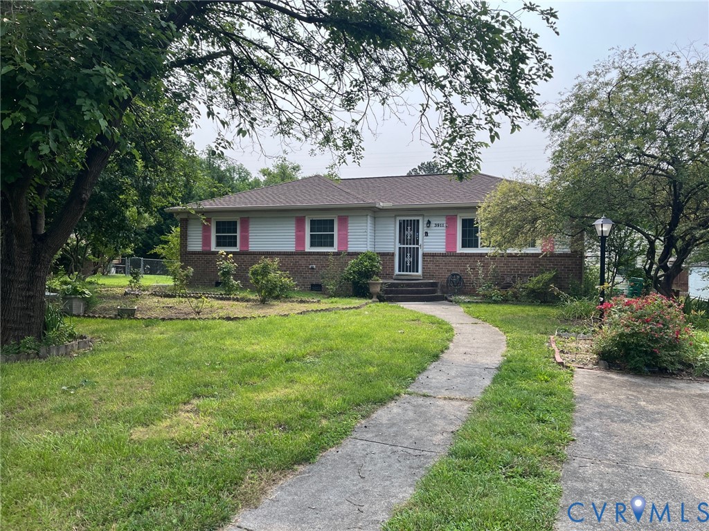 a front view of house with yard and green space
