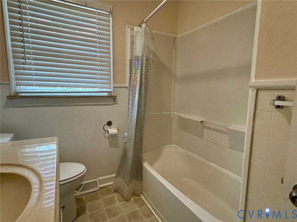 3911 Sunburst Road Henrico, VA 23294 - Photo 17 of 27 a bathroom with a granite countertop bathtub and a shower