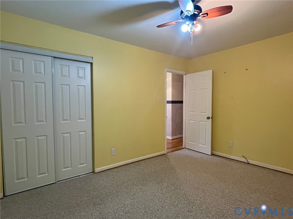 3911 Sunburst Road Henrico, VA 23294 - Photo 20 of 27 an empty room with a chandelier fan and a chandelier fan