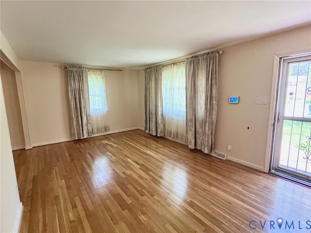 3911 Sunburst Road Henrico, VA 23294 - Photo 4 of 27 an empty room with wooden floor and windows
