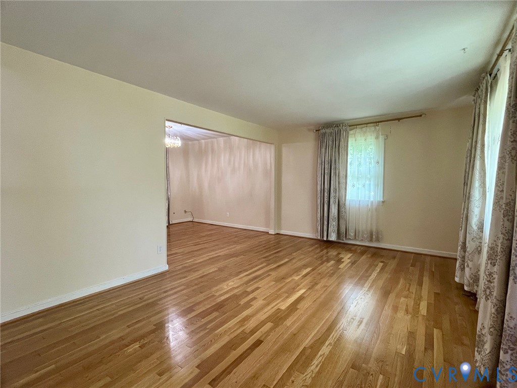 3911 Sunburst Road Henrico, VA 23294 - Photo 6 of 27 an empty room with wooden floor and windows