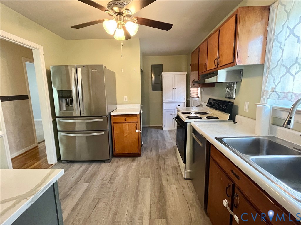 3911 Sunburst Road Henrico, VA 23294 - Photo 8 of 27 a kitchen with a refrigerator sink and wooden cabinets
