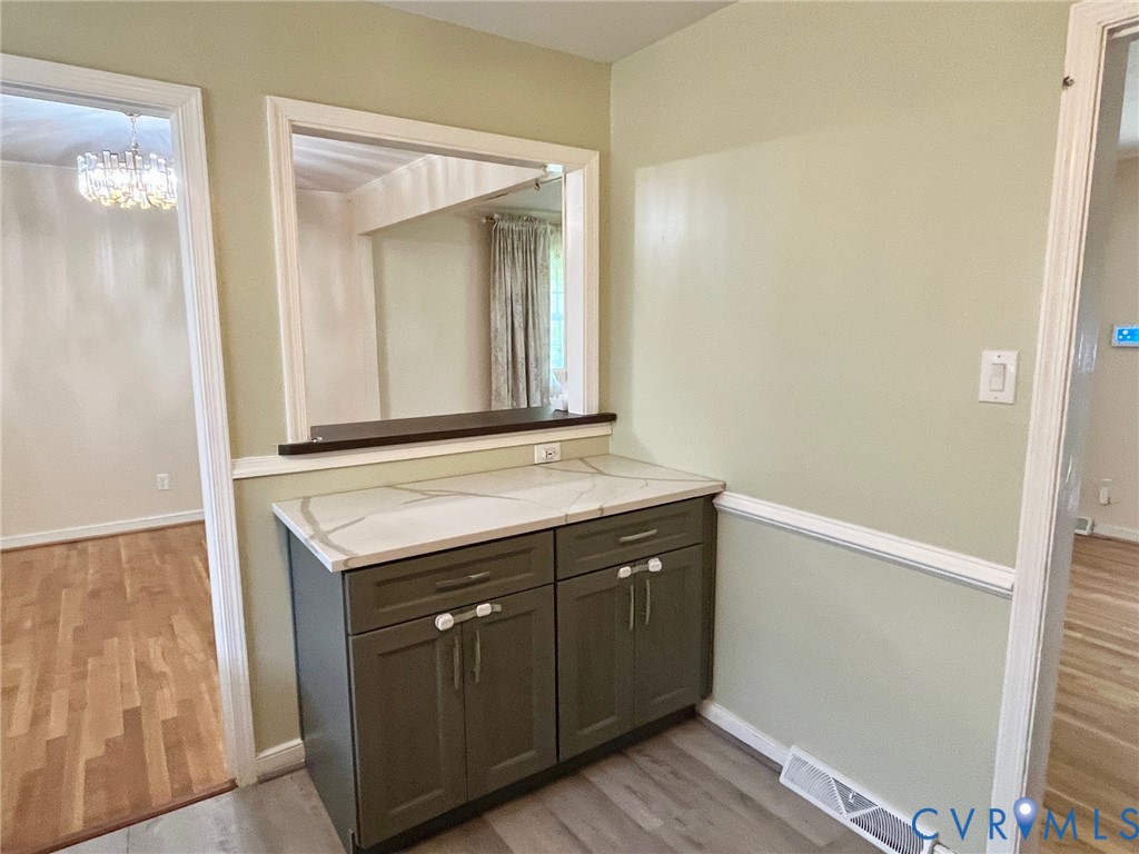 3911 Sunburst Road Henrico, VA 23294 - Photo 10 of 27 a bathroom with a granite countertop sink and a mirror