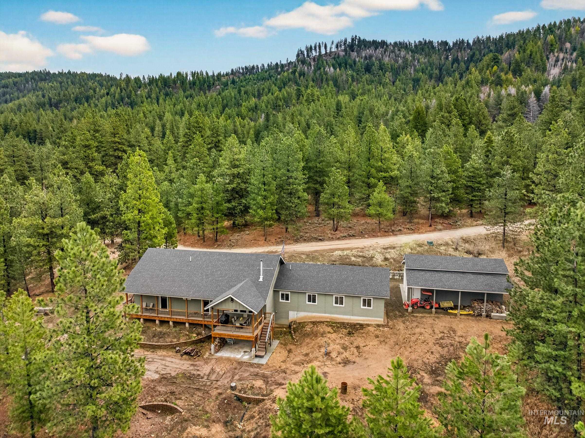10191 Timberrim Drive Cascade, ID 83611 - Photo 41 of 44 Aerial view of property and surrounding area with a heavily wooded area