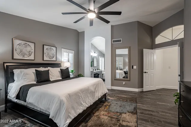 a bedroom with a bed and a lamp