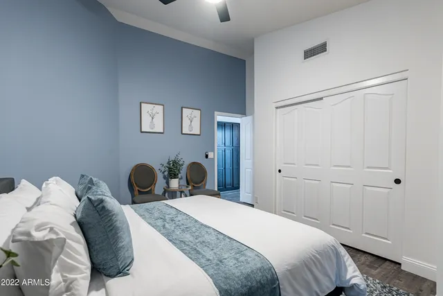 a view of a dining room and livingroom with furniture wooden floor a chandelier
