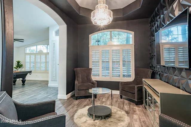 a living room filled with furniture and a potted plant