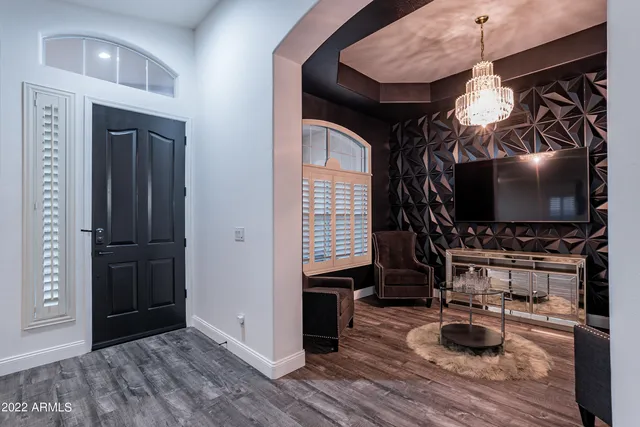 a living room with furniture and a mirror