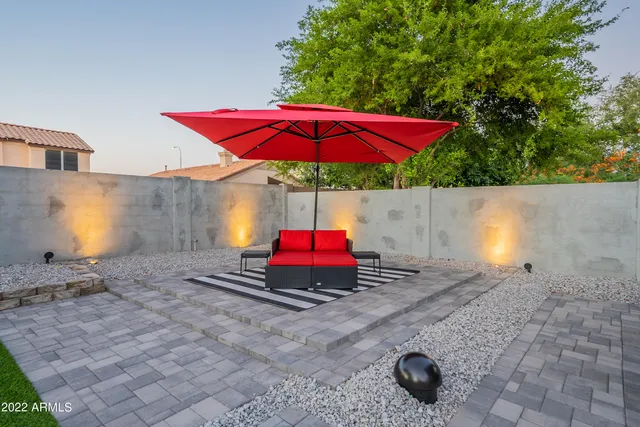 a view of a house with swimming pool and sitting area