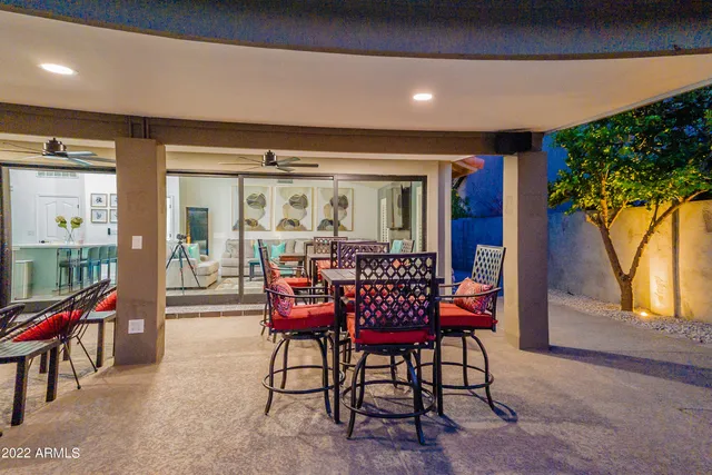 a view of an ocean with boats and trees in the background