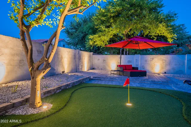 a view of swimming pool with sitting area and garden