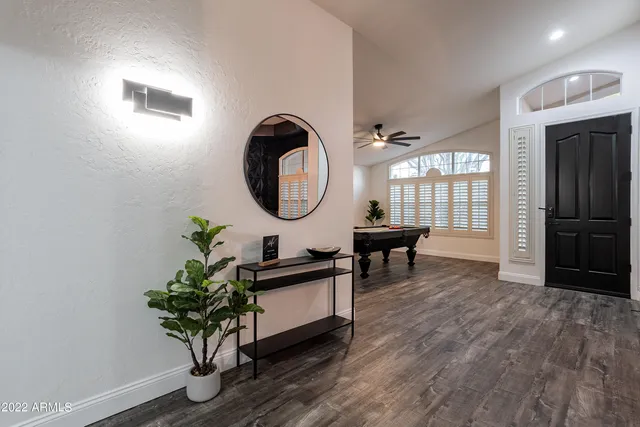 a living room with furniture a flat screen tv and a large window