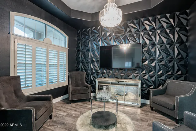 a living room with furniture and a chandelier