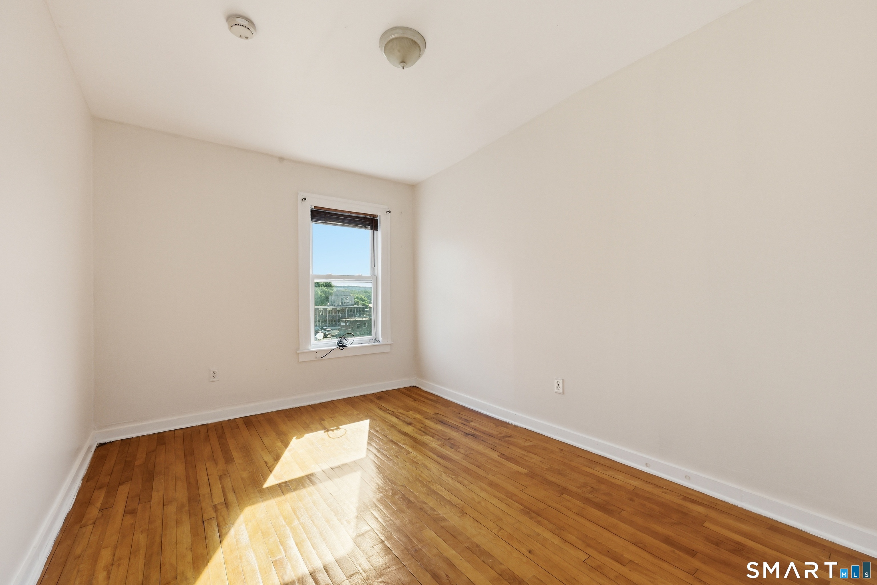 360 Main Street, Unit 3B Middletown, CT 06457 - Photo 11 of 21 a view of empty room with wooden floor and fan