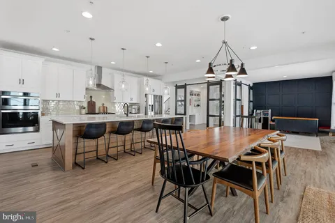 a view of kitchen with stainless steel appliances cabinets and window