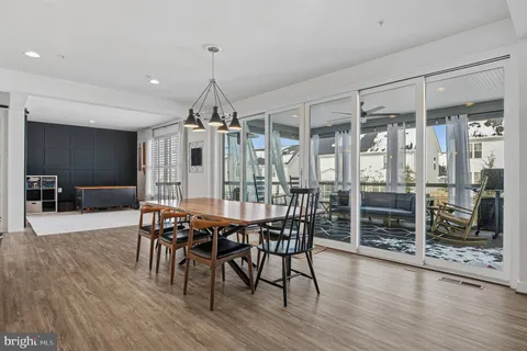 a kitchen with stainless steel appliances a white cabinets and a wooden floor