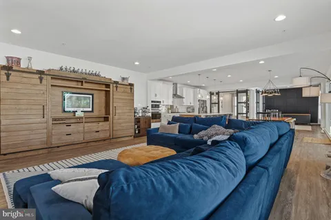 a living room with furniture and a floor to ceiling window