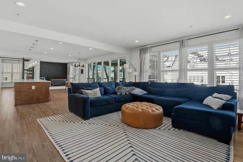 a living room with furniture a fireplace and a large window