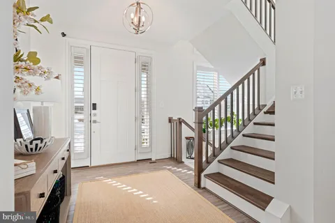 a view of a hallway with wooden floor and closet
