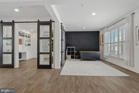 a bedroom with a bed and a flat tv screen on dresser