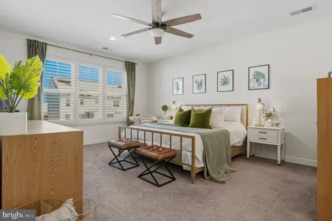 a bedroom with a bed and a lamp on the table