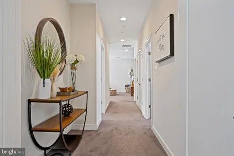 a view of a workspace with furniture and wooden floor