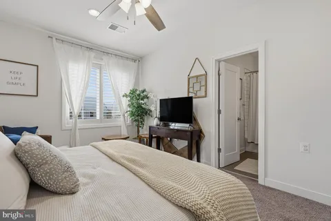 a bathroom with a sink toilet vanity and shower