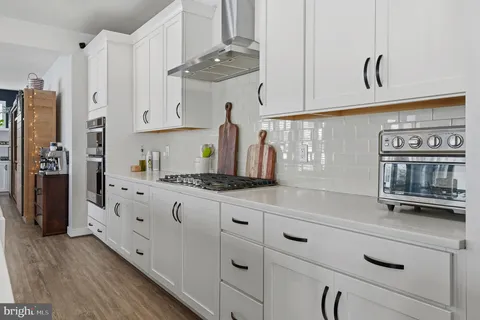 a dining room with furniture window and wooden floor