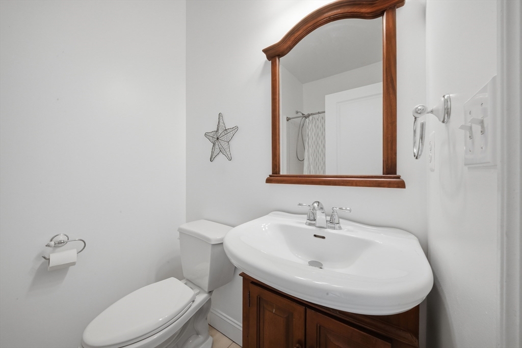 233 Beach Road, Unit A11 Salisbury, MA 01952 - Photo 18 of 37 a bathroom with a sink a toilet and mirror