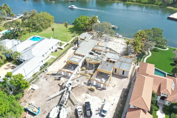 an aerial view of a house with outdoor space and lake view