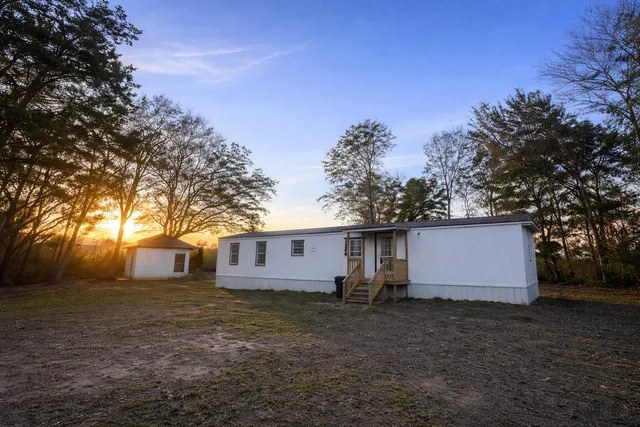 a view of a house with a backyard
