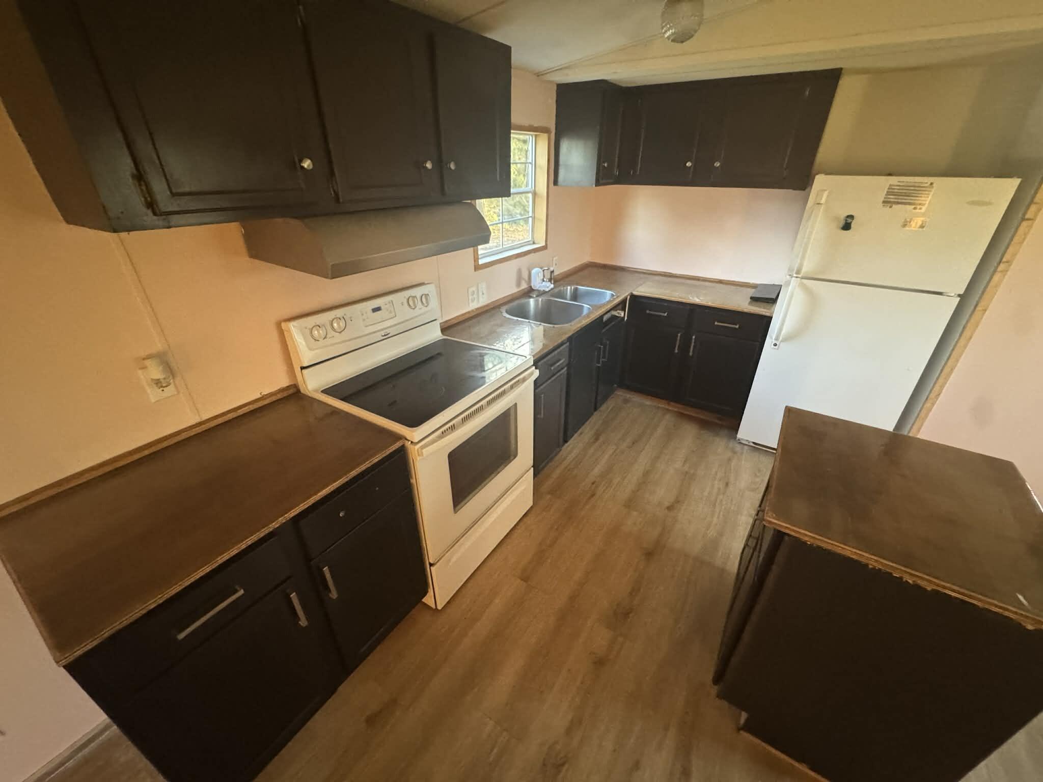 1893 Mathews Road Westville, FL 32464 - Photo 7 of 11 a kitchen with wooden cabinets and a stove top oven