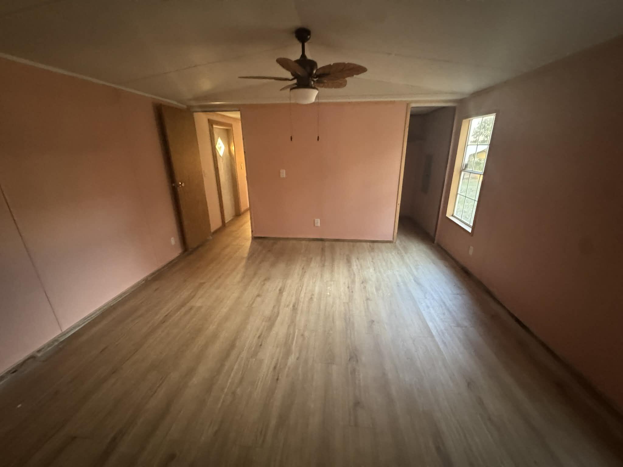 1893 Mathews Road Westville, FL 32464 - Photo 10 of 11 an empty room with wooden floor and windows