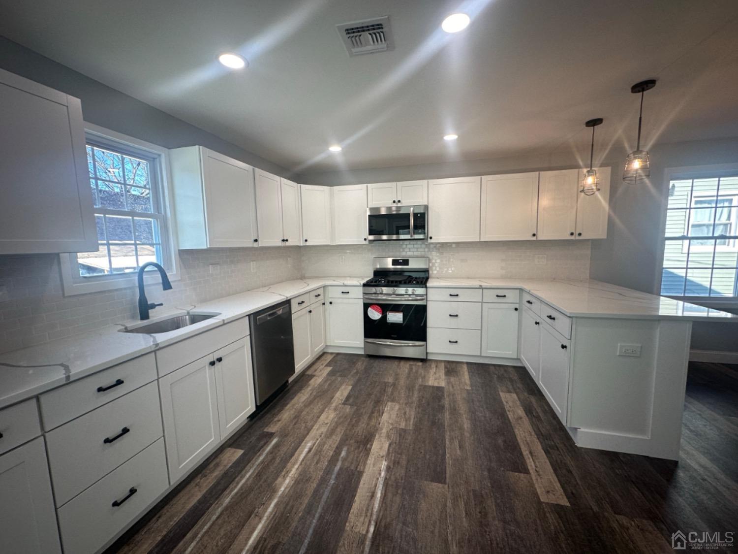 52 Central Avenue Sewaren, NJ 07064 - Photo 5 of 29 a kitchen with cabinets a sink and dishwasher stove