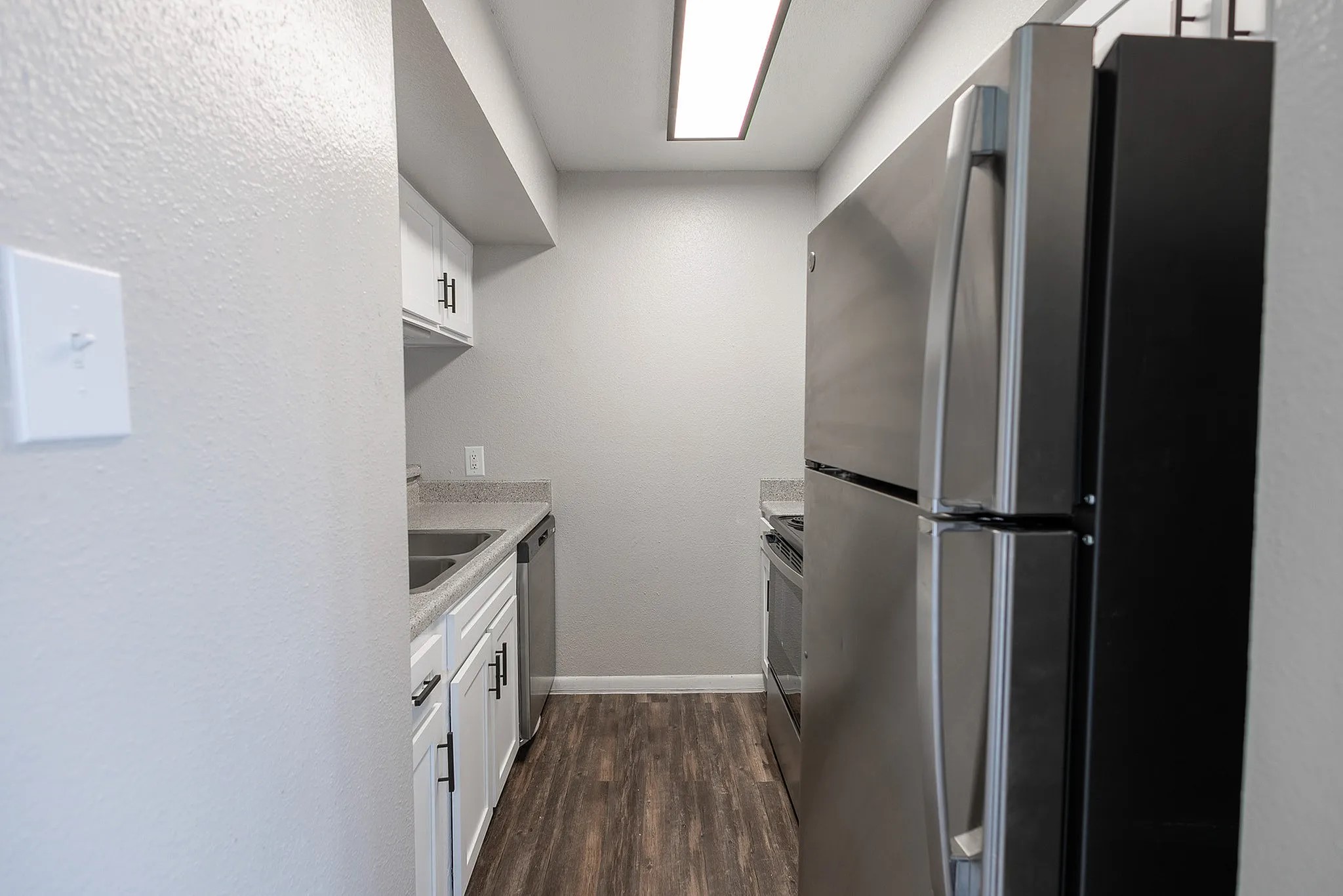 15100 Golden Eagle Drive, Unit 1309 Humble, TX 77396 - Photo 19 of 22 a kitchen with a refrigerator and a stove