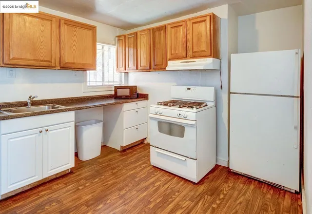 a kitchen with a white cabinets and white appliances
