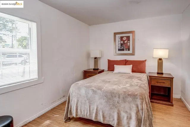 a bedroom with a bed and a window