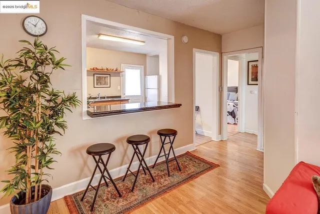 a view of a room with furniture and wooden floor