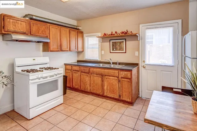 a kitchen with a stove sink and cabinets