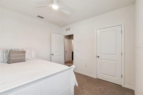 a bedroom with a bed and a lamp